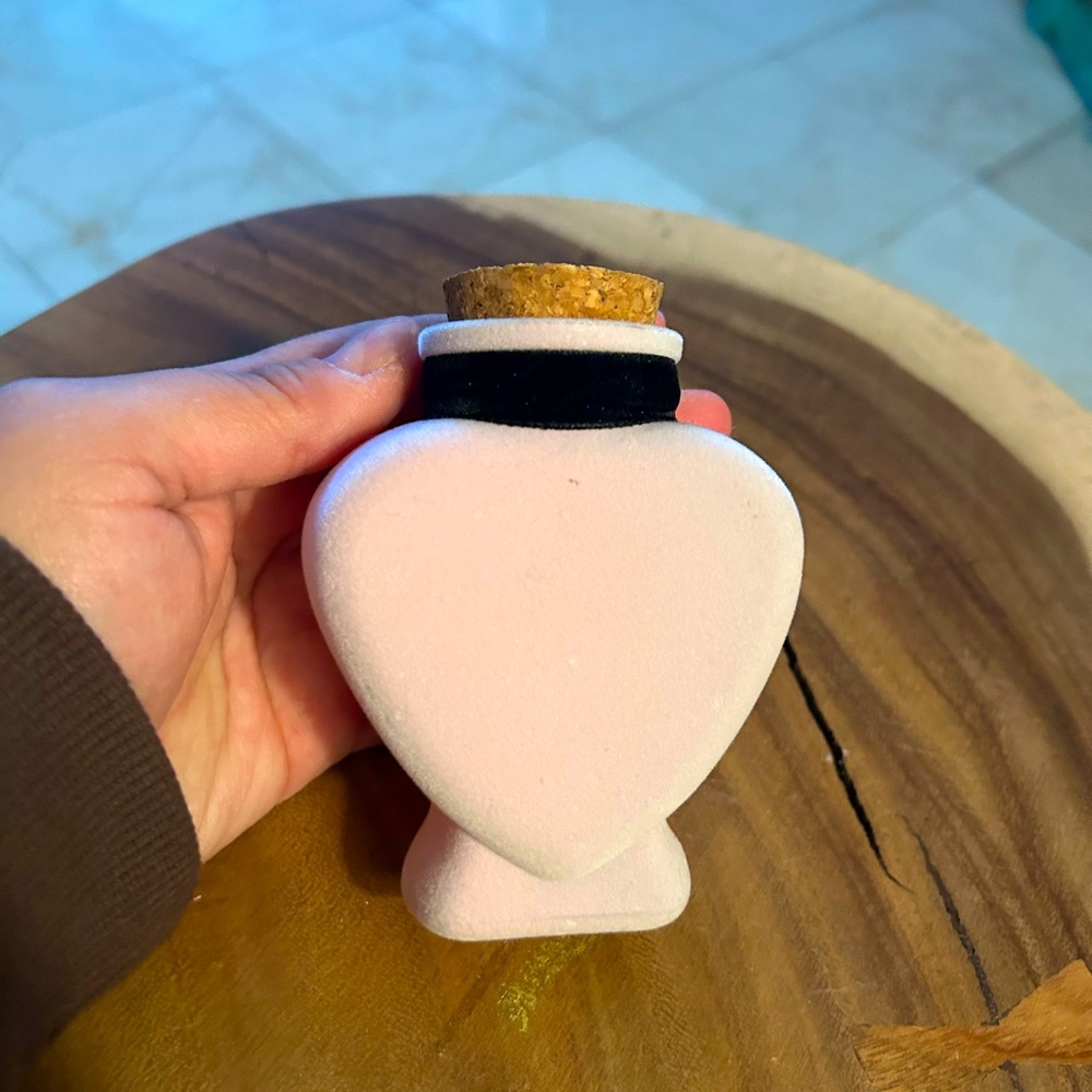 Light pink flocked heart shaped bottle